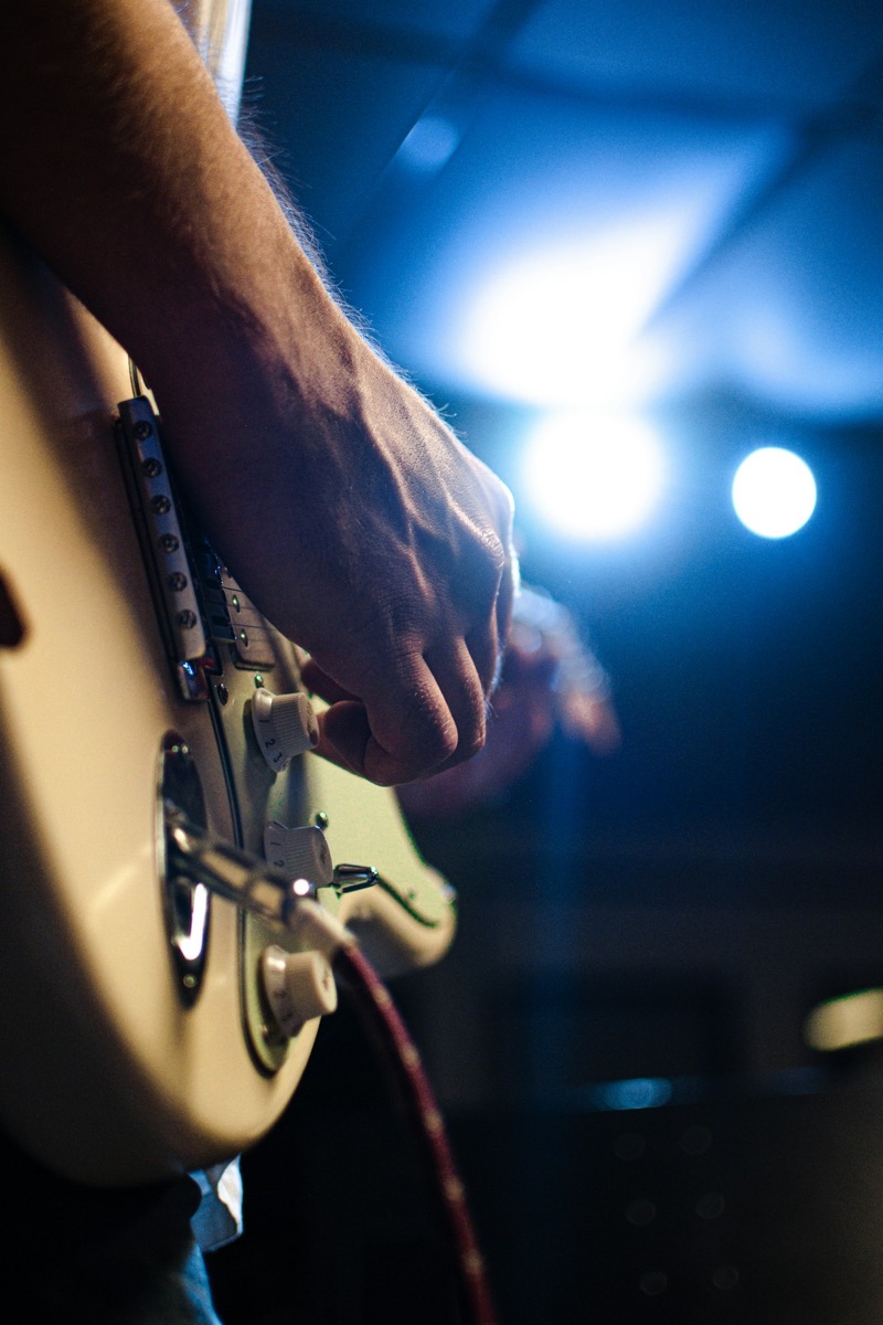 A guitarist recording in the studio